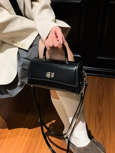Classic black rectangular handbag with silver twist lock and top handle for commute