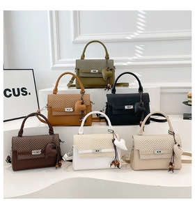 Close-up of stylish textured patchwork handbags in six colors with wooden bead charms