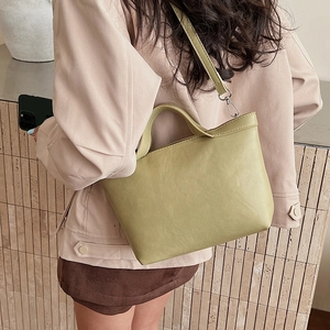 Avocado green tote bag detail showing wide handle and adjustable shoulder strap style