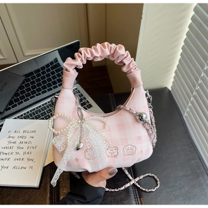 Detail of pink plaid handbag with pearl bow, bear embroidery and lace charm