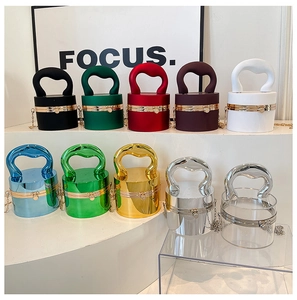 Various colors of cylindrical acrylic bags with U-shaped handles and gold chain straps