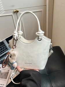 Creamy white PU leather bucket bag with cute bear charm and adjustable shoulder strap