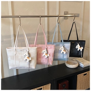 Detail view of large canvas tote bags in four colors with vintage geometric patterns