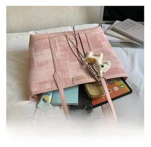 Top view of pink tote bag interior showing capacity for tablets and daily items