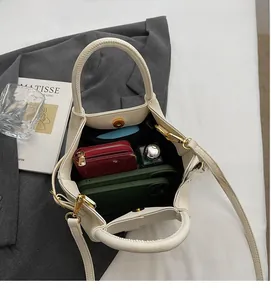 Vue de dessus du sac seau crème montrant un grand espace intérieur pour téléphone et portefeuille