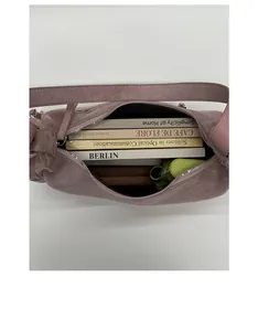 Top-down view of the spacious inner compartment of the pink suede shoulder bag