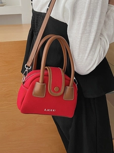 Stylish red canvas square crossbody bag with brown leather handles for women