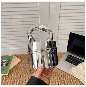 Macro shot of silver cylindrical clutch with liquid handle and polished metallic finish