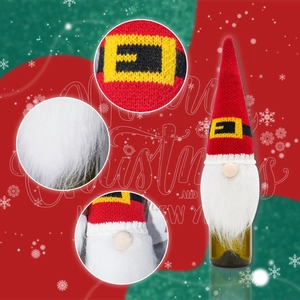 Close-up of Christmas gnome wine bottle cover with red knit hat and white plush beard detail