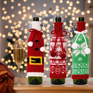 Three-piece knitted Christmas wine bottle covers with Santa belt, deer, and snowflake motifs