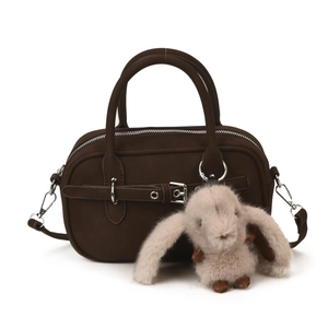 Vintage dark brown suede Boston bag with long-eared bunny pendant on white background