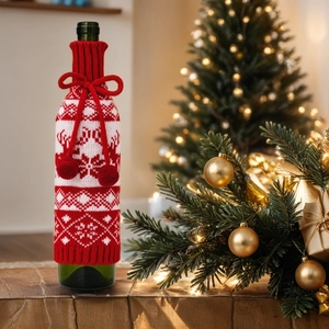 Knitted Christmas wine bottle cover with elk pattern and festive pompom details
