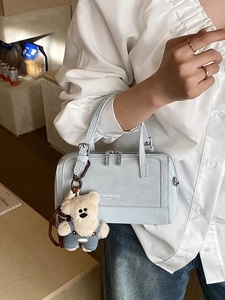 Light blue Boston style handbag with a cute teddy bear charm and silver metal accents