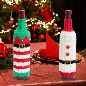 Detail of knitted Christmas wine bottle covers with belt and bell decorations