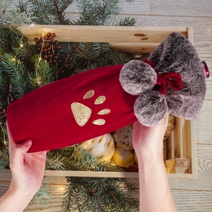 Plush hot water bottle cover in deep red velvet with gold paw embroidery and grey faux fur