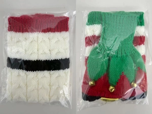 Close-up of Christmas knitted bottle covers with festive stripes and golden bell detail
