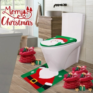 Close-up of Santa Claus toilet seat cover and matching U-shaped non-slip bathroom rug