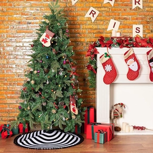 Classic black and white striped Christmas tree skirt with festive holiday decorations