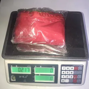 Detailed weighing of red knitted elf sack in transparent bag showing 0.217kg weight