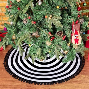 Classic round Christmas tree skirt with black and white stripes and black pom-pom fringe