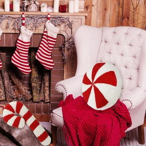 Detail of red and white peppermint candy and cane plush pillows with sherpa texture
