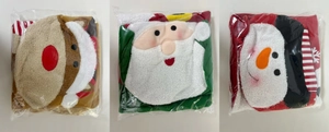 Close-up of Christmas themed toilet covers featuring reindeer, Santa, and snowman designs