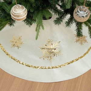 Close-up of cream Christmas tree skirt featuring golden snowflakes and sequin trim