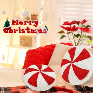Detail of red and white peppermint candy plush pillow with soft textured Sherpa fabric