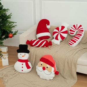 Detailed view of festive Christmas theme decorative pillows on cozy knitted sofa blanket