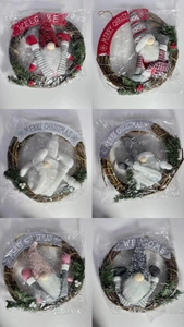 Detail of Christmas gnome wreaths with pine needles and festive Merry Christmas banner
