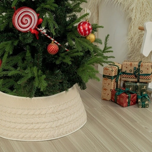 Macro detail of cream cable knit Christmas tree collar base with festive decor