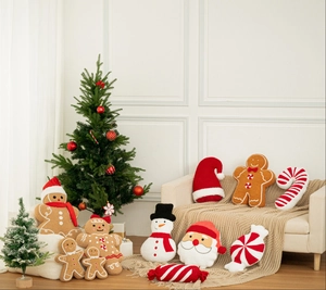Cozy festive plush pillow assortment with gingerbread man and candy cane on sofa
