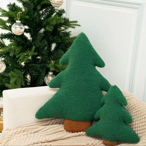 Deep green Christmas tree shaped plush pillows set on a cozy sofa for holiday home decor