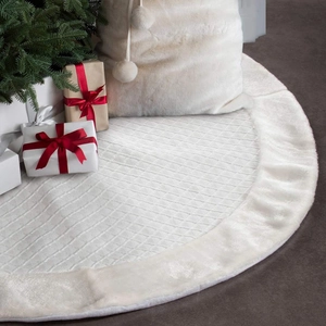 Detail of white quilted Christmas tree skirt with plush faux fur edge and diamond pattern