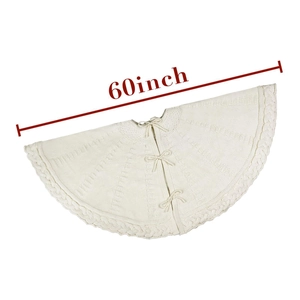Detail of 60-inch white knitted Christmas tree skirt with classic cable patterns