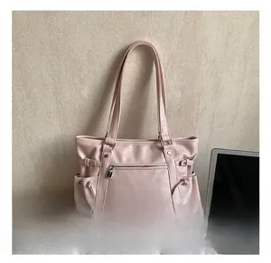 Detail view of pink PU leather tote bag with functional zipper pocket and side drawstrings
