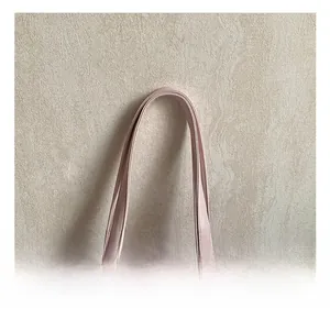 Detail showing soft pink PU leather tote dual handles with silver metal hardware rivets
