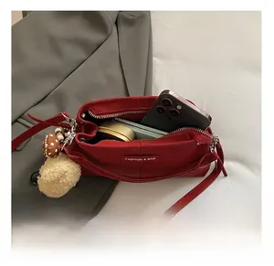 Top view of red bucket bag interior showing spacious storage for phone and cosmetics