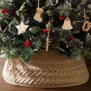 Detail of chunky cable knit Christmas tree collar in beige with a festive texture