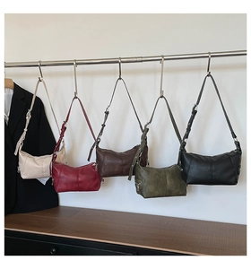Detailed view of semi-circle Hobo bags in five vintage colors with metal zipper accents