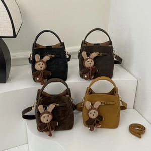 Chic bucket handbags in four colors featuring cute bunny plush charms and shoulder straps