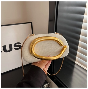 Close-up of beige woven clutch with iconic gold round handle and fine metal chain