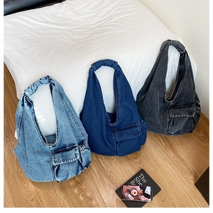 Three washed denim hobo bags in blue and grey showing cargo pocket and wide strap details