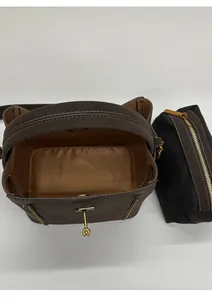 Top view of spacious interior of the brown leather bucket bag with a black inner pouch