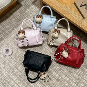 Detail of Boston tote bags in five colors with cute plush bear charms and straps