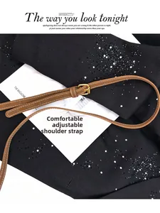 Detail of brown leather shoulder strap with gold buckle and white contrast stitching