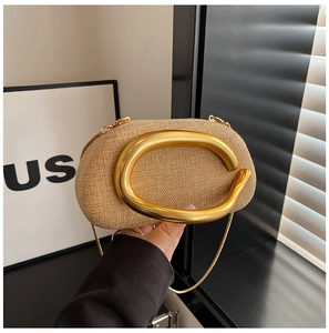 Detailed close-up of woven acrylic bag with curved gold handle and fine chain strap