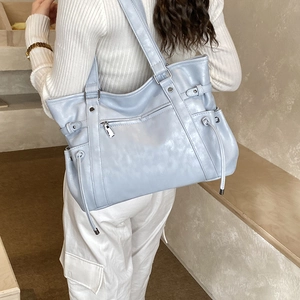 Light blue faux leather tote bag with silver zipper pocket and drawstring details