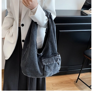 Detail view of washed dark grey denim tote bag with functional side cargo pocket