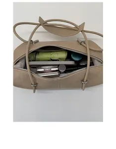 Spacious interior of beige Boston bag showing storage for umbrella and cosmetics